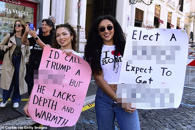 Demonstrators in Italy showed off their obscene signs calling Trump a 'c***' and a rapist