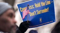People listen as Everett Kelley, President of the American Federation of Government Employees (AFGE) Union, during a "Save the Civil Service" rally outside the U.S. Capitol on February 11, 2025 in Washington, DC