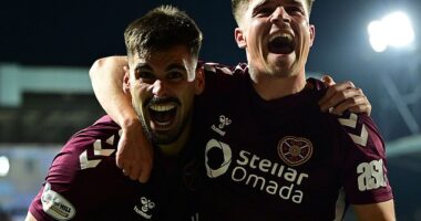 Braga and Devlin (right) celebrate after the striker put Hearts 2-0 ahead