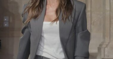 Beaming Victoria Beckham pulled her proud husband David in for a passionate kiss following her Paris Fashion Week show on Friday