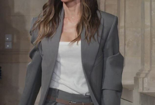 Beaming Victoria Beckham pulled her proud husband David in for a passionate kiss following her Paris Fashion Week show on Friday