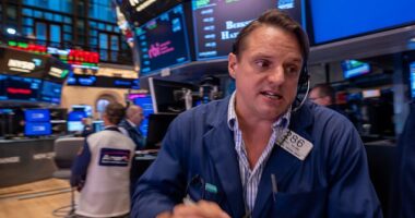 Traders work on the floor of the New York Stock Exchange on October 17