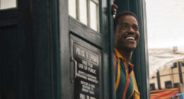 A smiling Ncuti Gatwa emerging from the TARDIS door in Doctor Who season 2 episode "The Story & The Engine"