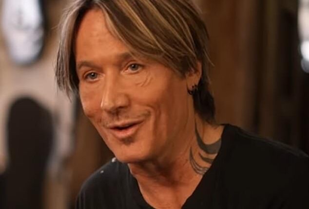 Keith Urban (pictured) is 'in hiding' as he shakes off the 'embarrassment' of his split with wife Nicole Kidman, according to a report