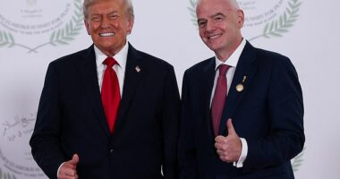 US President Donald Trump and FIFA president Gianni Infantino (right) pose for a photo at the Sharm El Sheikh Peace Summit in Egypt today