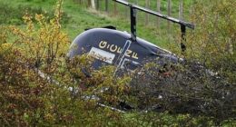 The helicopter landed on its side in a field near an industrial estate in Bentley shortly after 10am