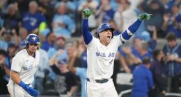 Toronto Blue Jays' George Springer, right, celebrates after hitting a three-run home