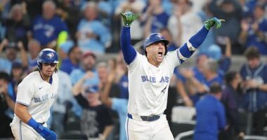 Toronto Blue Jays' George Springer, right, celebrates after hitting a three-run home