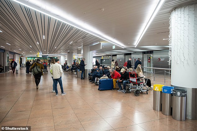 Brussels Airport is closed after the reported sighting of a drone, said the Belgian air traffic control service and a spokeswoman for the airport. Pictured: Travellers wait in an empty departure hall at Zaventem airport as air traffic is suspended following a reported drone sighting, in Zaventem outside Brussels, on November 4, 2025