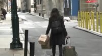 A guest is seen abruptly leaving the Sonder hotel she was staying at in Philadelphia with her luggage in tow