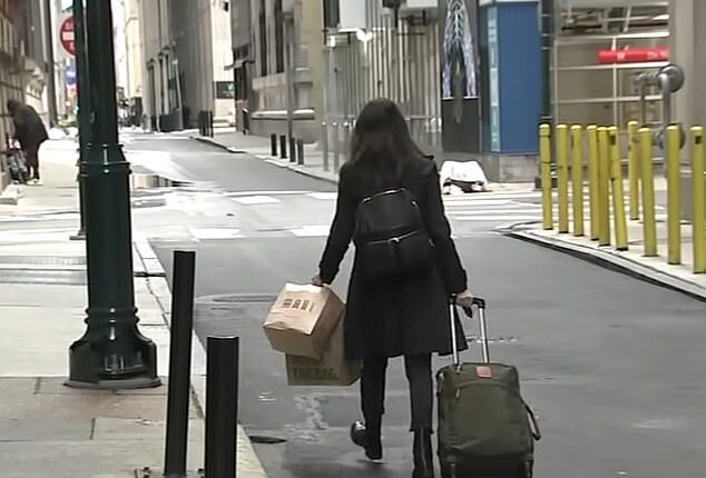 A guest is seen abruptly leaving the Sonder hotel she was staying at in Philadelphia with her luggage in tow