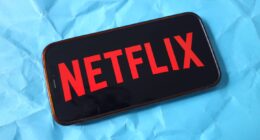 In this photo illustration, the Netflix company logo is seen...