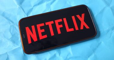 In this photo illustration, the Netflix company logo is seen...
