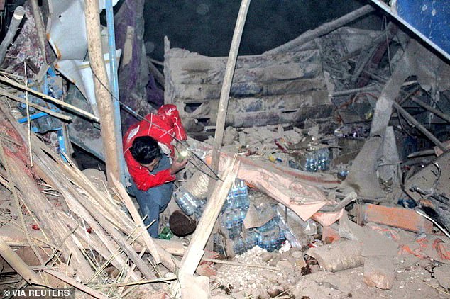 A rescuer works following an earthquake at an unidentified location in Afghanistan, in this handout image released November 3, 2025