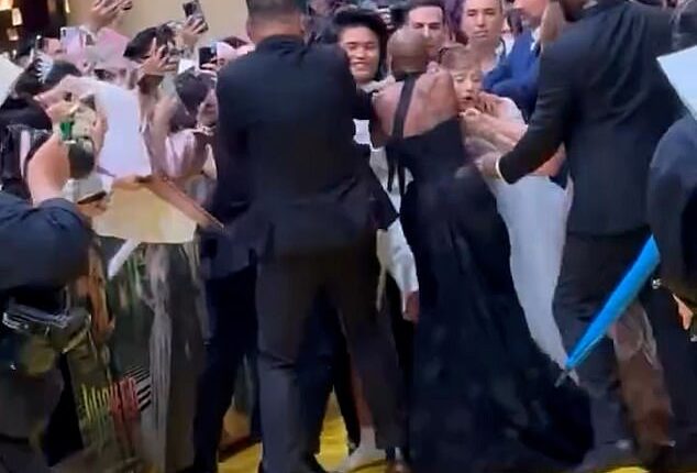 Ariana Grande was ambushed by an overzealous fan while walking the red carpet at the Singapore premiere of her new film Wicked: For Good on Thursday