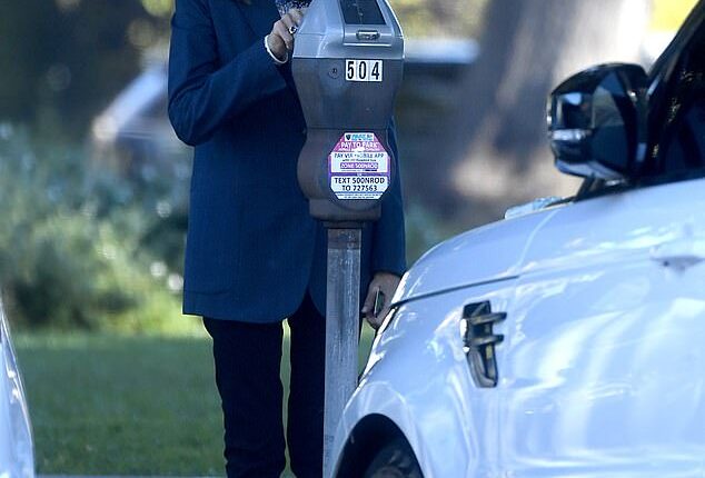 Lovely Barbara feeds the meter in Beverly Hills during a trip into town for a meeting
