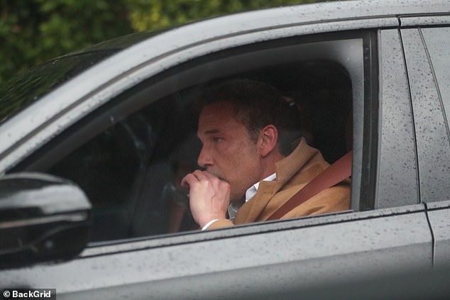 Ben Affleck was spotted warming himself up with a cigarette while dashing around Los Angeles as the city was finally hit by autumn showers