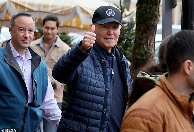 Former President Joe Biden, wearing a black baseball cap, gave a thumbs-up towards photographers as he and he his family walked the streets of Nantucket