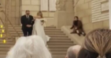 A wedding planner appeared to upstage a bride on her big day by sliding down the stairs