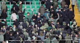 Celtic fans turn their back and make gestures during the minute's silence to mark the war dead