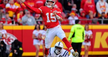 Patrick Mahomes #15 of the Kansas City Chiefs attempts a pass while under pressure from Adetomiwa Adebawore #95 of the Indianapolis Colts in the third quarter