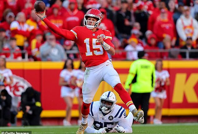 Patrick Mahomes #15 of the Kansas City Chiefs attempts a pass while under pressure from Adetomiwa Adebawore #95 of the Indianapolis Colts in the third quarter