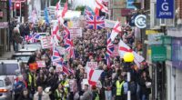 Protesters in Crowborough, East Sussex, hold placards and march through the town centre this morning over plans to house 600 male asylum seekers at Crowborough Training Camp