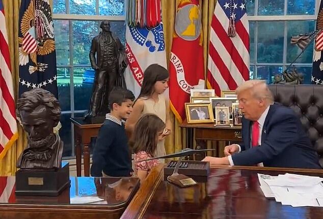 Trump introduces himself to one of the young children as 'Donald'