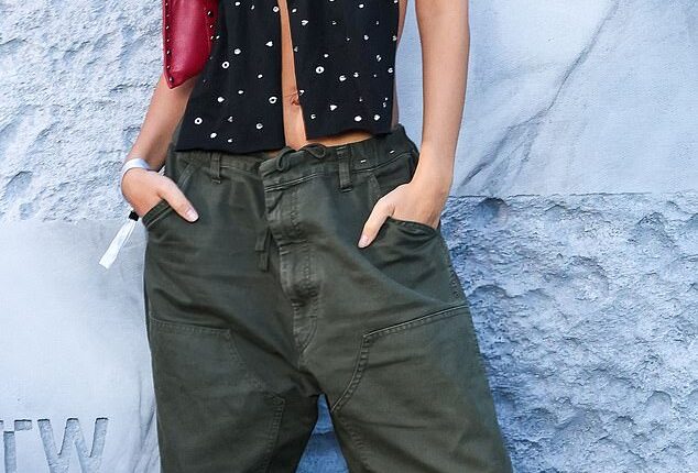 Model Emily Ratajkowski is pictured wearing oversized khaki cargo trousers in Paris in 2024 for a Vans event