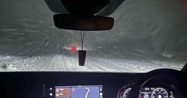 Motorist seen driving through the dangerous snowy conditions