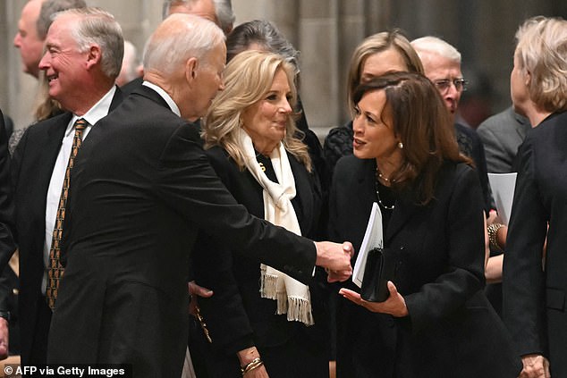 Jill Biden (center) was captured pursing her lips as her husband (left) greeted his former VP Kamala Harris, their first reunion since Harris's tell-all was released in September