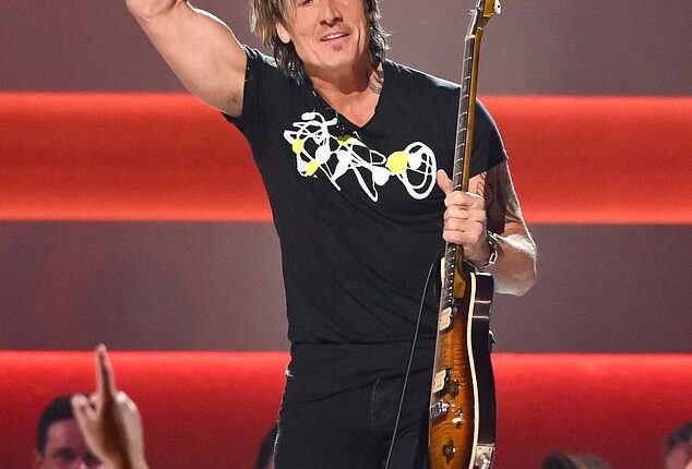 Keith Urban stunned the audience at the CMA Awards in Nashville on Monday by appearing onstage for a surprise duet with hostess Lainey Wilson
