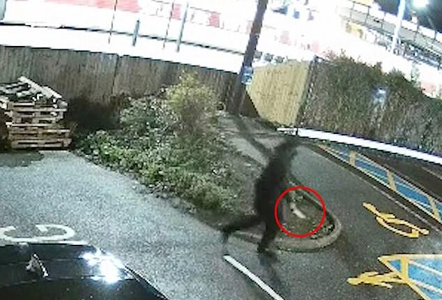 Chilling: The black-clad man holding a knife strolls away from the train after causing carnage. Sources confirmed that the suspect had a history of mental-health issues and was known to the authorities previously