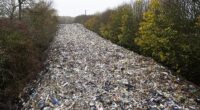 The 20ft-high pile of hazardous rubbish was illegally dumped in a field next to the A34 and River Cherwell near Kidlington in Oxfordshire