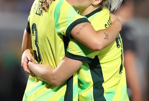 Matildas defender Ellie Carpenter embraces Winonah Heatley during their match against New Zealand