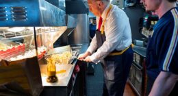 Donald Trump works behind the counter during a visit to McDonalds in Feasterville-Trevose, Pennsylvania, U.S. October 20, 2024