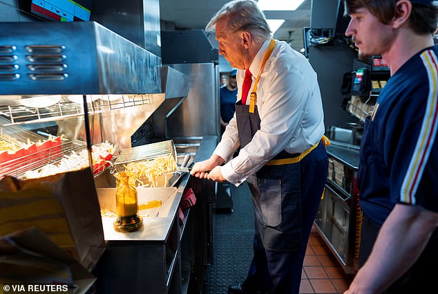 Donald Trump works behind the counter during a visit to McDonalds in Feasterville-Trevose, Pennsylvania, U.S. October 20, 2024