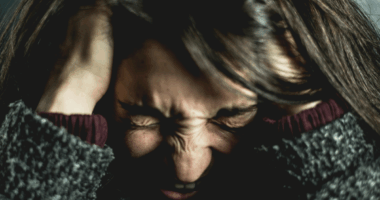 Woman holding her head