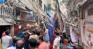 Residents stand in an alley after vacating their house next to a fallen scaffolding following an earthquake in Dhaka, Bangladesh, November 21, 2025