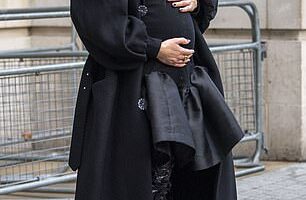 The expectant mother cradled her bump