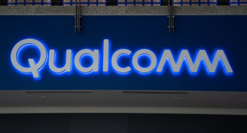 Qualcomm takes a big tax charge that hits earnings, and the stock falls
