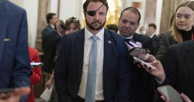 Rep. Dan Crenshaw, R-Texas, talks to reporters as he walks out of the House chamber during the 118th Congress in Washington, Wednesday, Jan. 4, 2023
