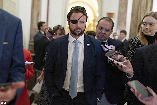 Rep. Dan Crenshaw, R-Texas, talks to reporters as he walks out of the House chamber during the 118th Congress in Washington, Wednesday, Jan. 4, 2023