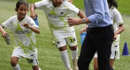 Sweet moment Prince William plays football with local children and meets Brazilian football legend Cafu during visit to iconic Maracana stadium in Rio de Janeiro