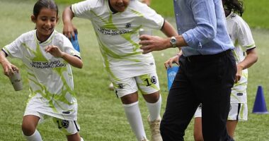 Sweet moment Prince William plays football with local children and meets Brazilian football legend Cafu during visit to iconic Maracana stadium in Rio de Janeiro