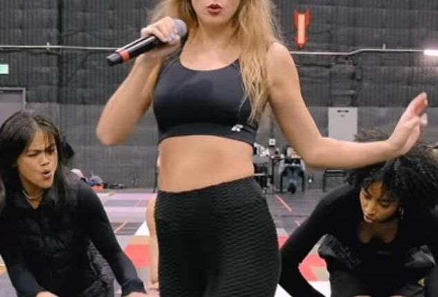 Taylor Swift has been seen in rare behind-the-scenes footage working hard at her Eras Tour dance routines in her new documentary as the first trailer dropped on Thursday