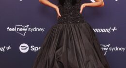 UK pop star Olivia Dean set the tone early on the red carpet, breaking up her sleek all-black outfit with a striking white rose on her corset and minimal accessories of a simple bracelet and matching earrings