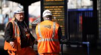 Brits racing home for Christmas face an unprecedented rail network shutdown - as a staggering 32 days of works are set to close main lines and hit 2,500 trains. (File image of Network Rail engineers in London Waterloo)