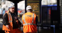 Brits racing home for Christmas face an unprecedented rail network shutdown - as a staggering 32 days of works are set to close main lines and hit 2,500 trains. (File image of Network Rail engineers in London Waterloo)