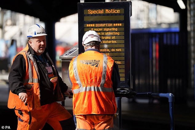 Brits racing home for Christmas face an unprecedented rail network shutdown - as a staggering 32 days of works are set to close main lines and hit 2,500 trains. (File image of Network Rail engineers in London Waterloo)